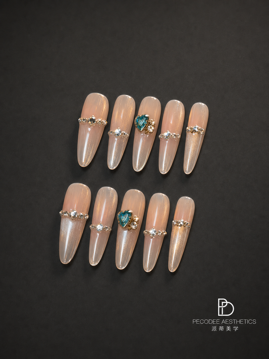 Glossy peach acrylic nails set with pearl and aqua gemstone embellishments, almond shape