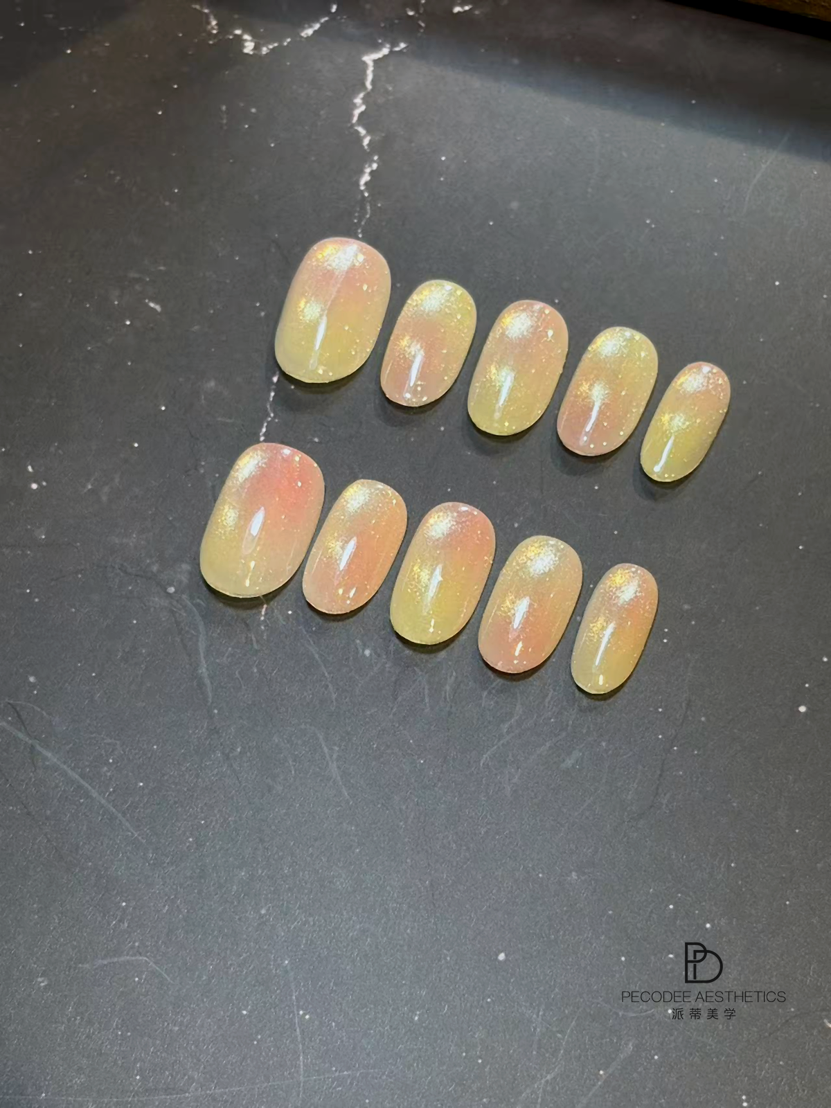 Press-on nails set with pastel yellow and peach glitter gradient, oval shape