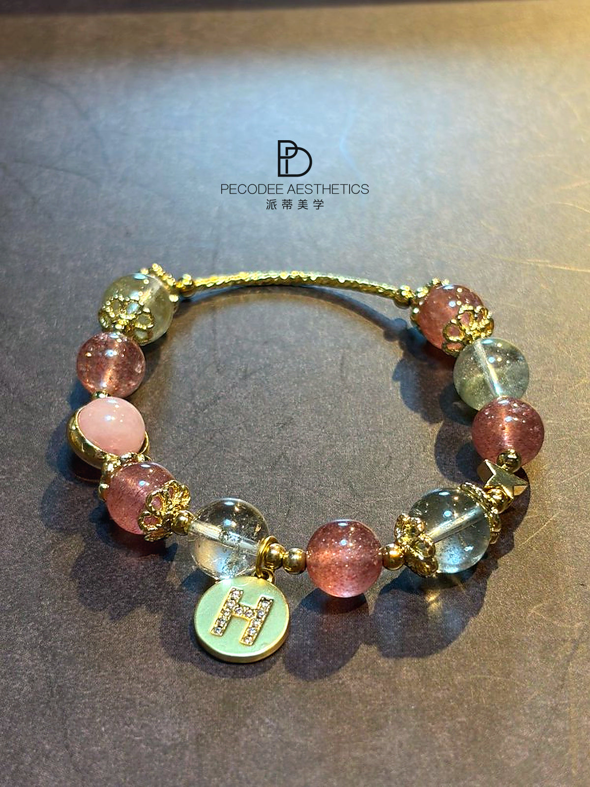 Multicolor beaded charm bracelet with gold-tone settings and round pastel bead accents