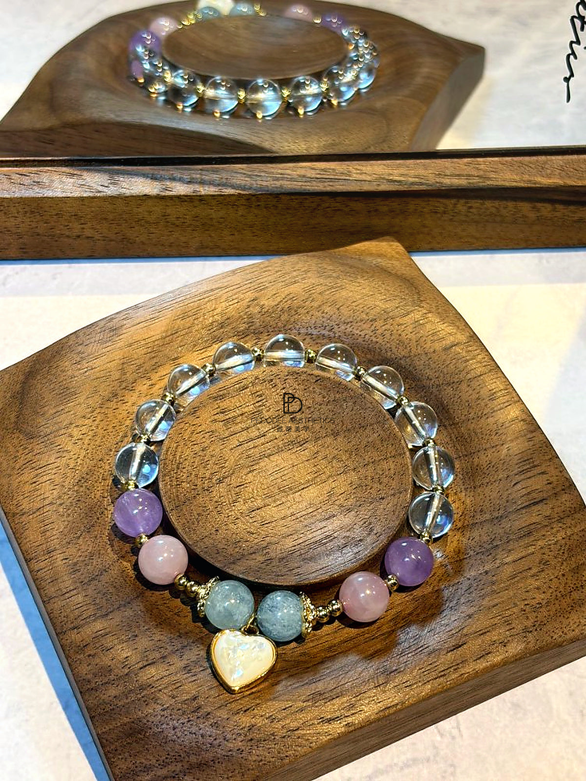 Beaded bracelet with heart pendant and pastel blue, pink, and purple stones on gold-tone chain