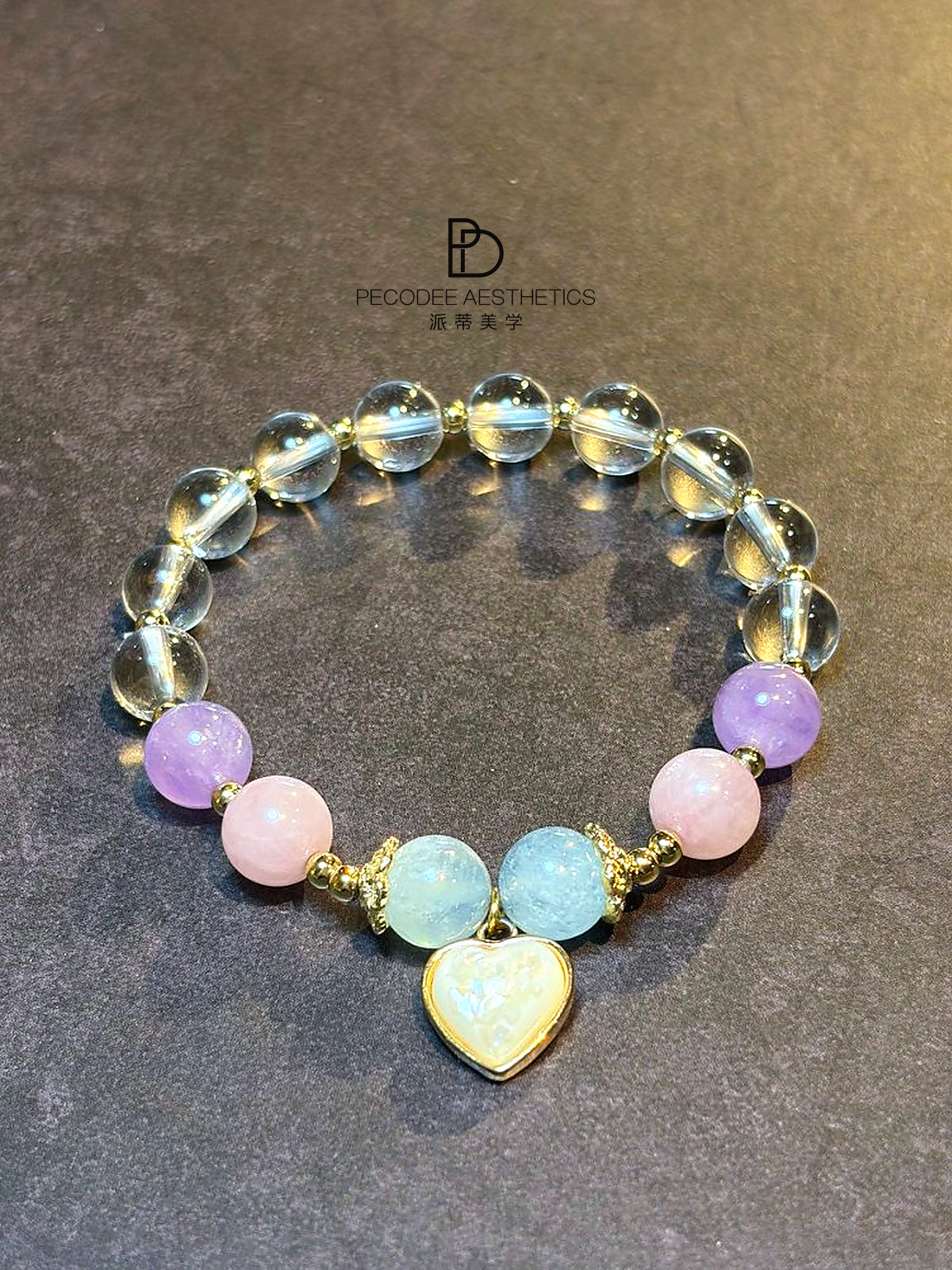 Heart charm beaded bracelet with opalescent blue, pink & purple beads, gold-tone links