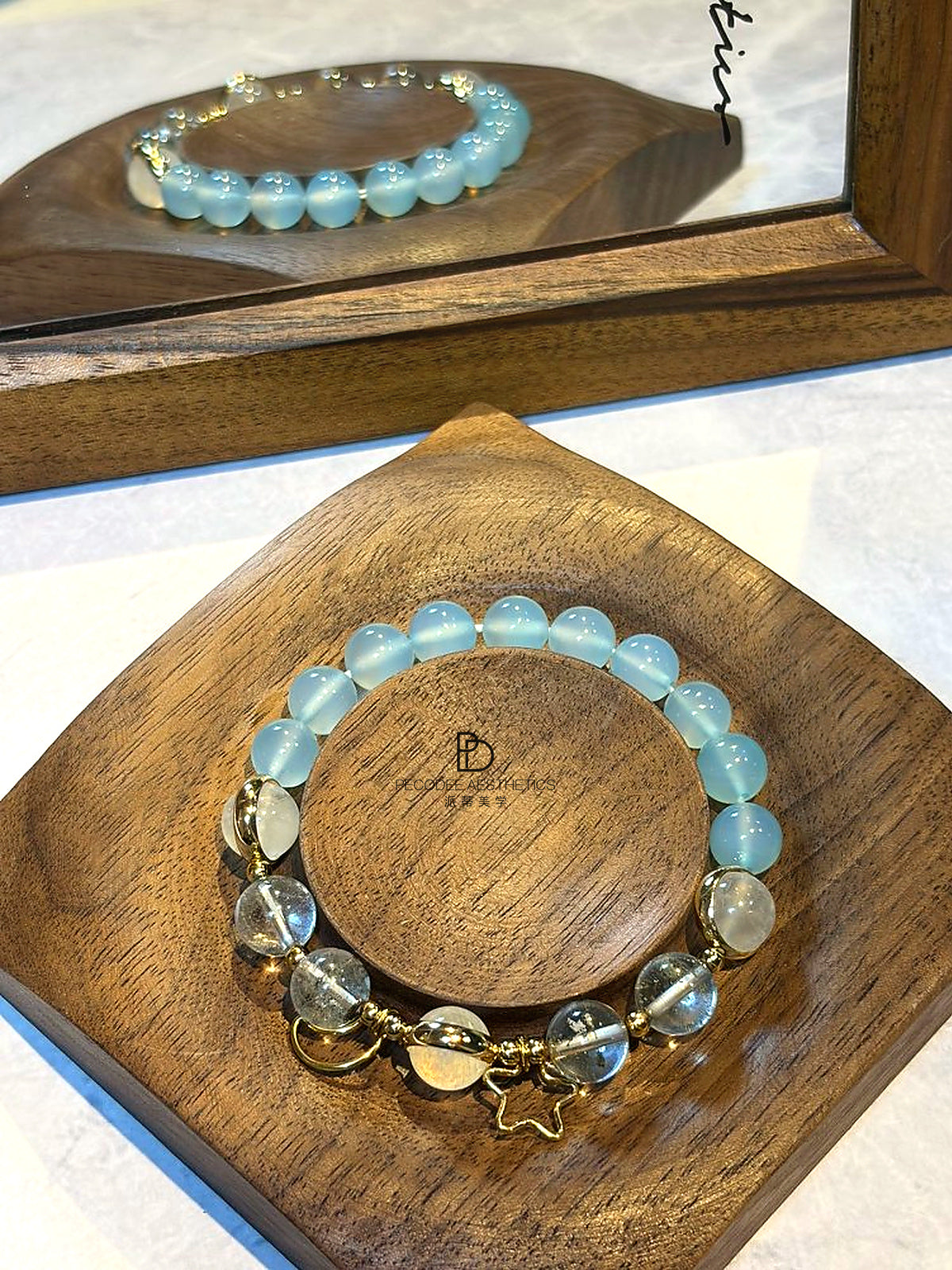 Blue beaded bracelet with gold-tone chain links and heart-shaped charm