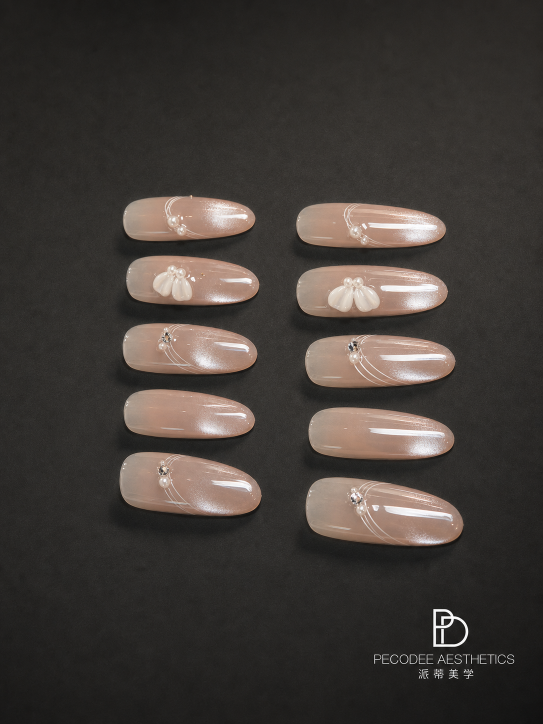 Pearl-carved press-on nail set with creamy nude oval tips and floral charms