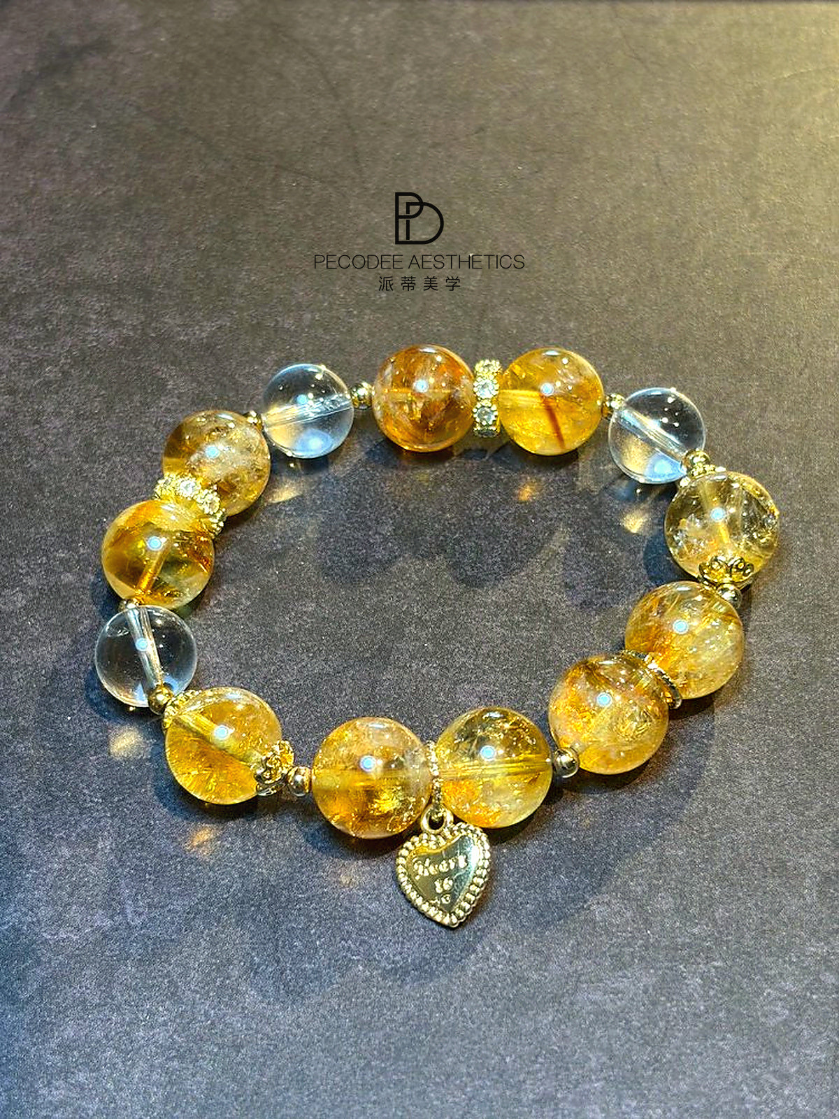 Beaded bracelet with amber-gold round beads, light blue glass beads, heart charm