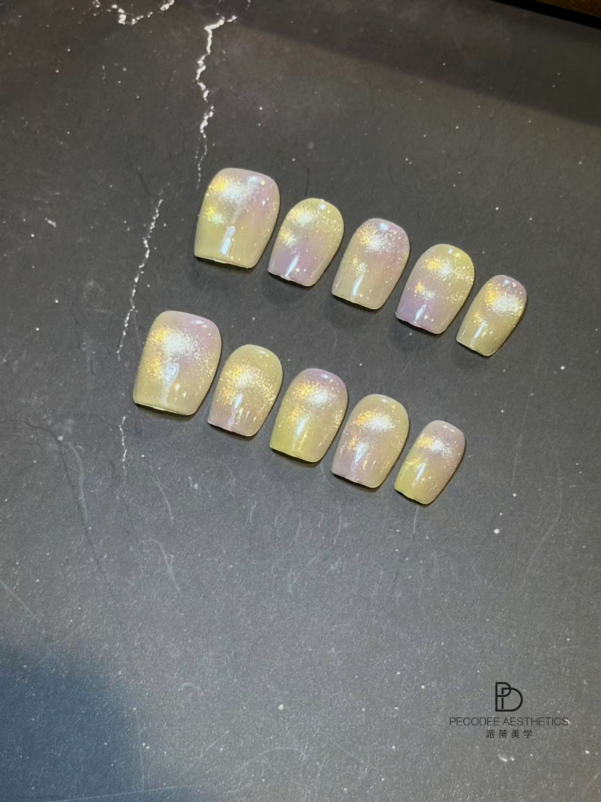 Iridescent yellow square nail tips with glossy ombre finish and glitter flecks