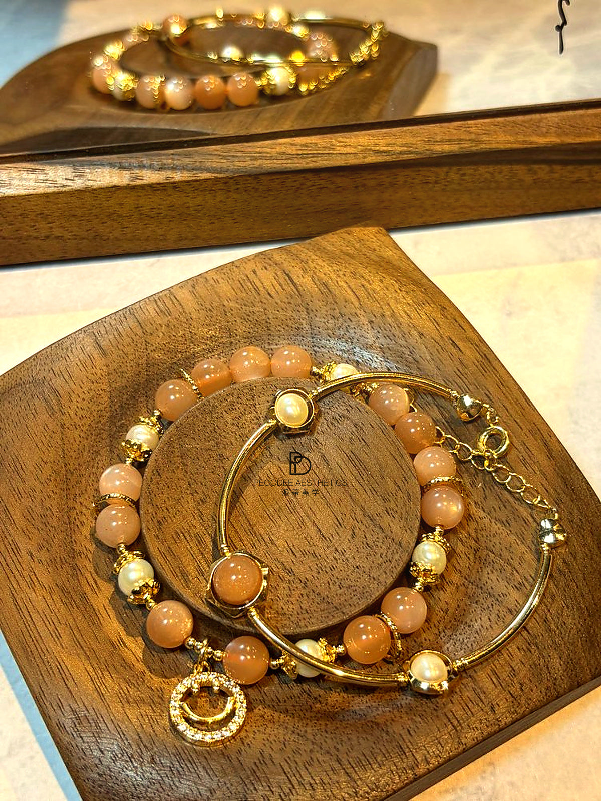 Orange and white pearl beaded bracelet with gold hoop bangle and crescent charm