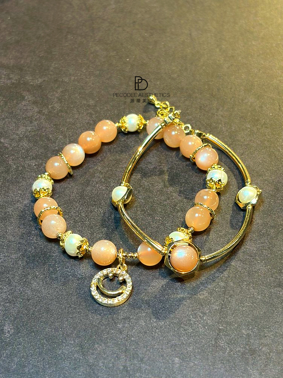 Gold-tone beaded pearl bracelet set with orange and white pearls, hoop bangles, charms