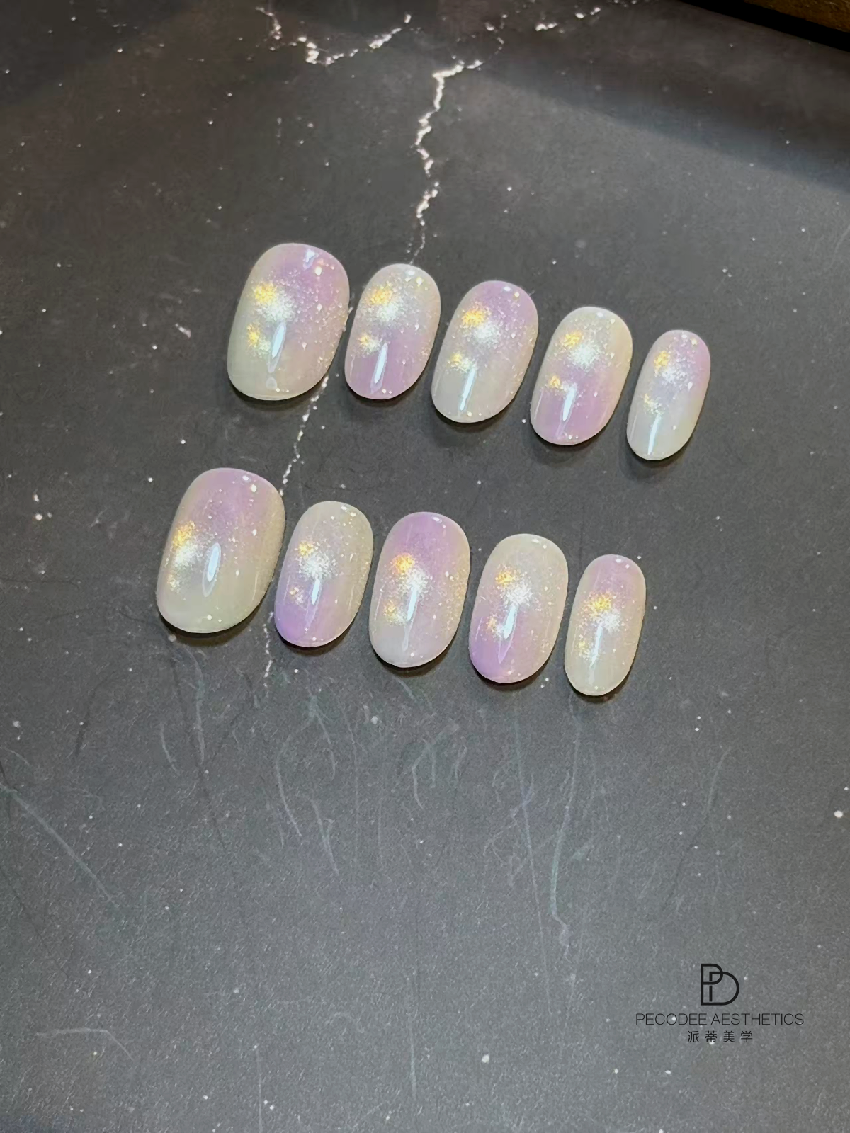 Pastel ombré press-on nails with iridescent glitter speckles, oval