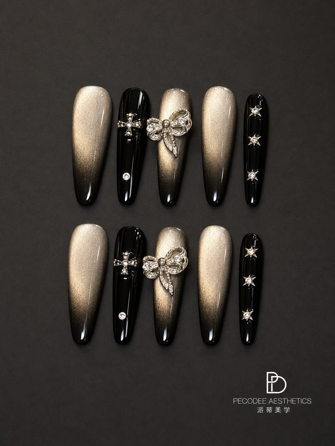 Champagne and black press-on nails with butterfly and star rhinestone accents