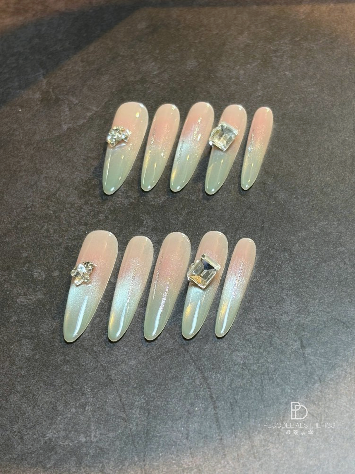 Mint Crystal nail set with mint ombre tips and gold crystal accents on five nails