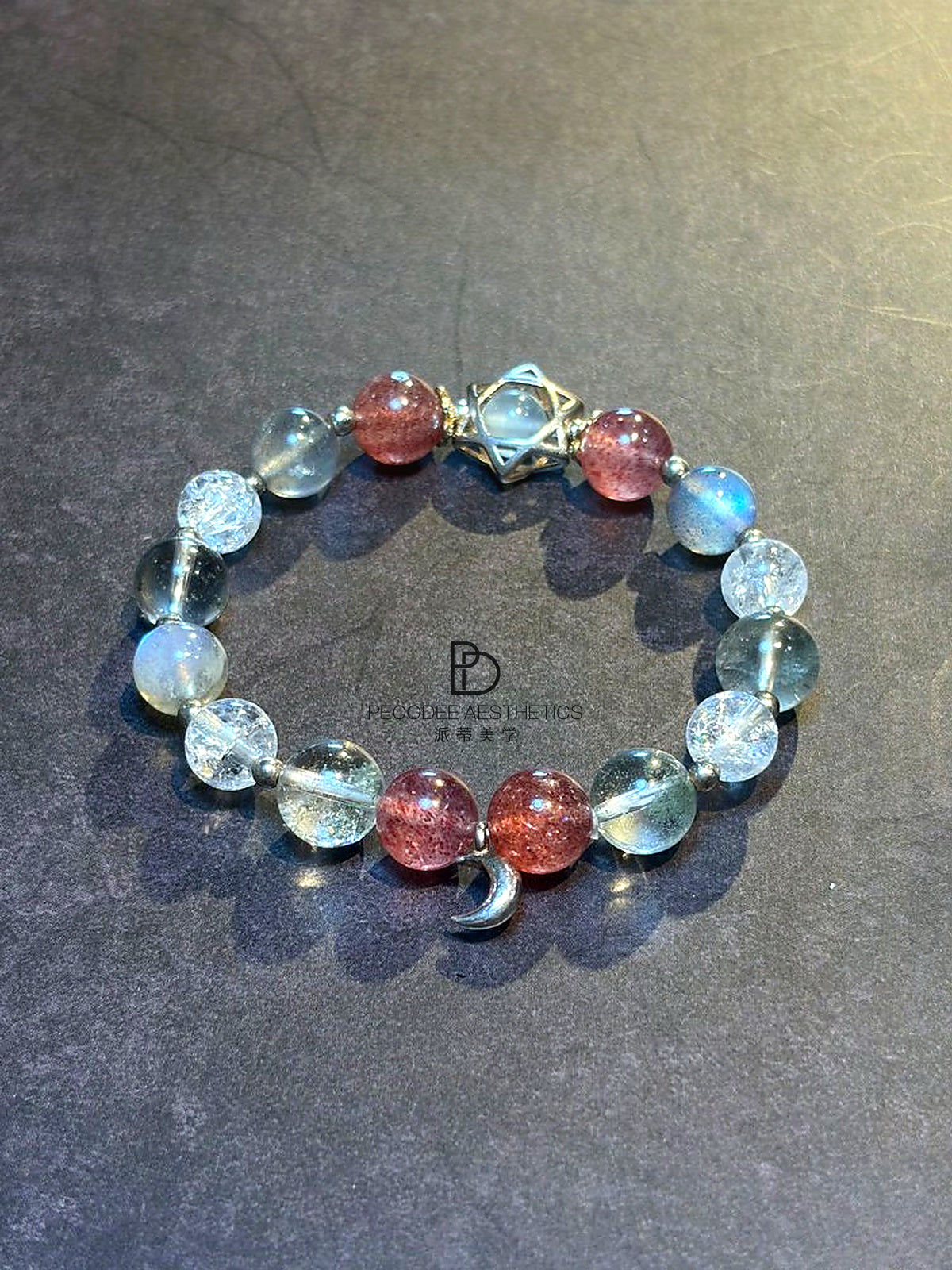 Beaded bracelet with clear and light-blue beads, berry-red beads, silver clasp charm