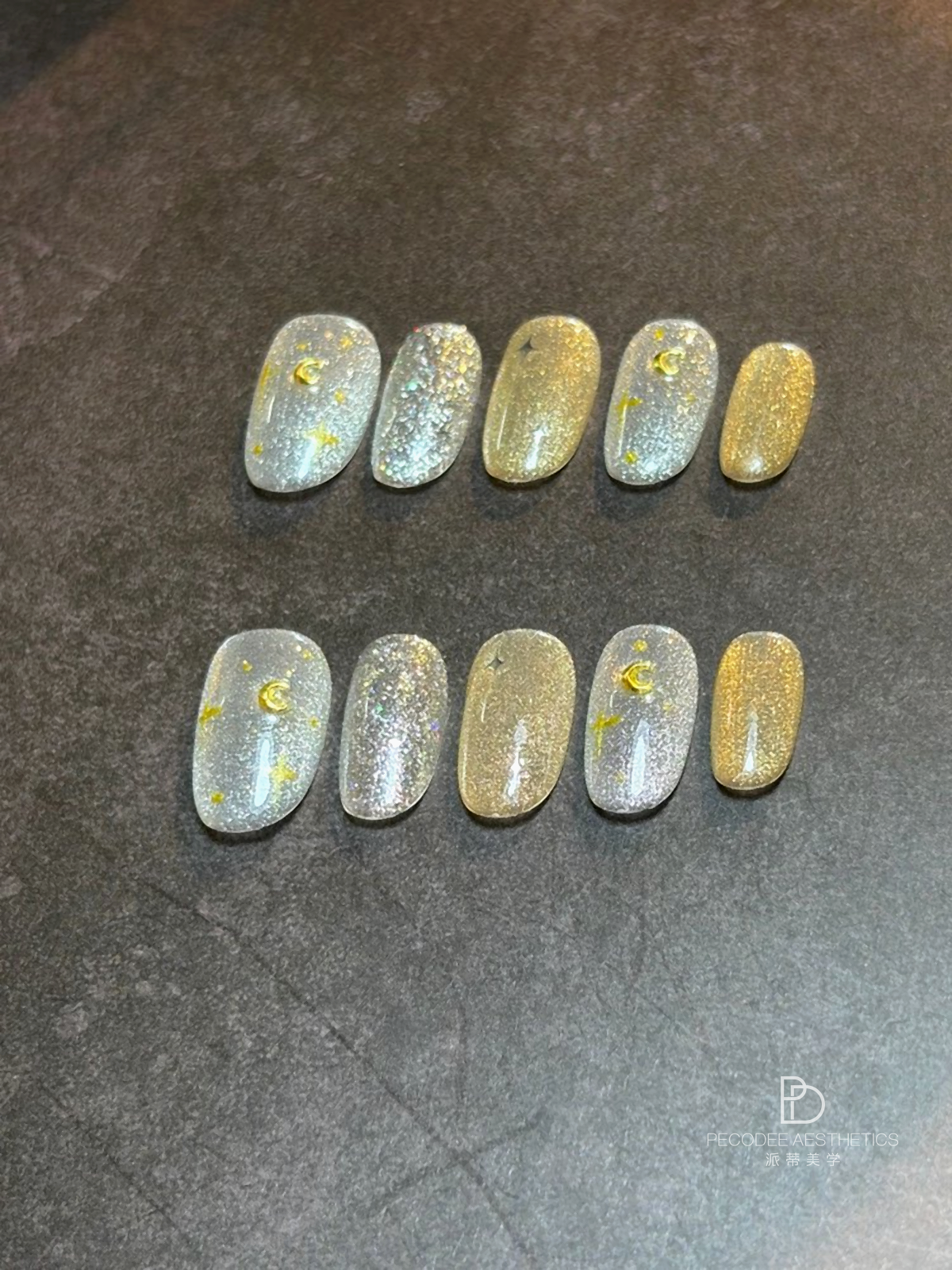 Glitter nail swatch set with silver-blue and gold glitter tips on a display card