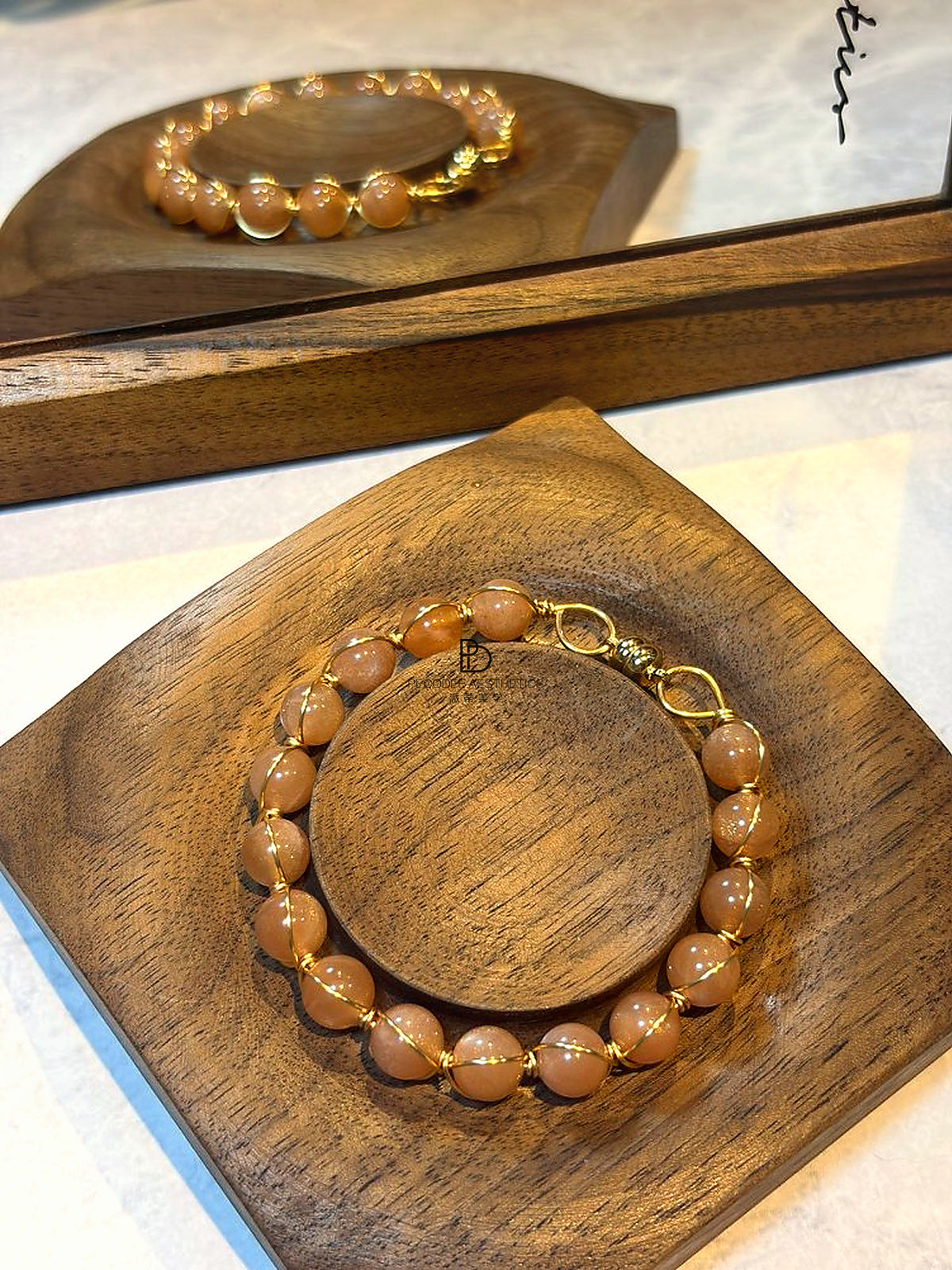 Orange gemstone bead bracelet with gold-tone clasp, round bead design