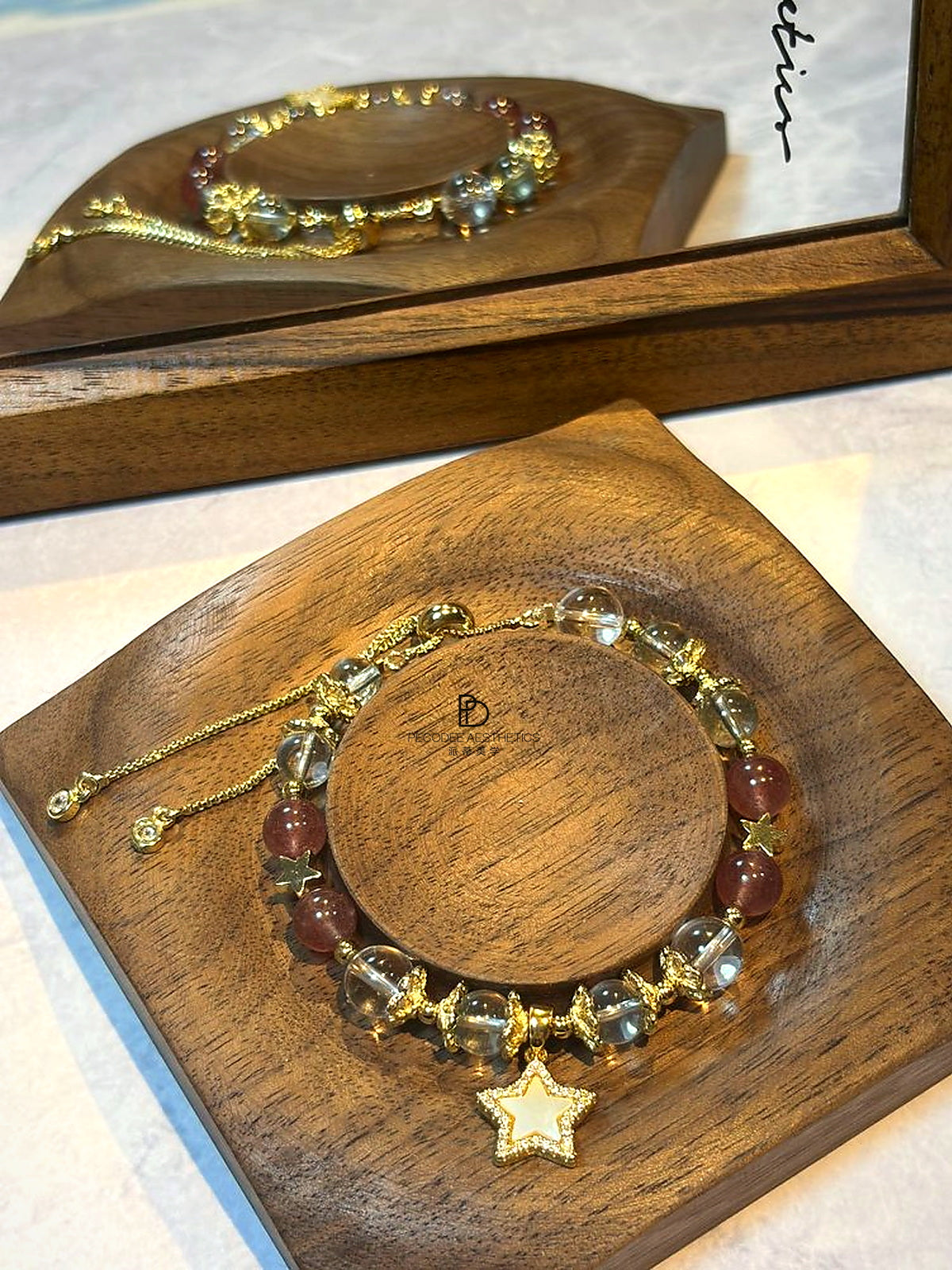 Bead bracelet with gold-tone beads, blue and amber spheres, and dangling star charm
