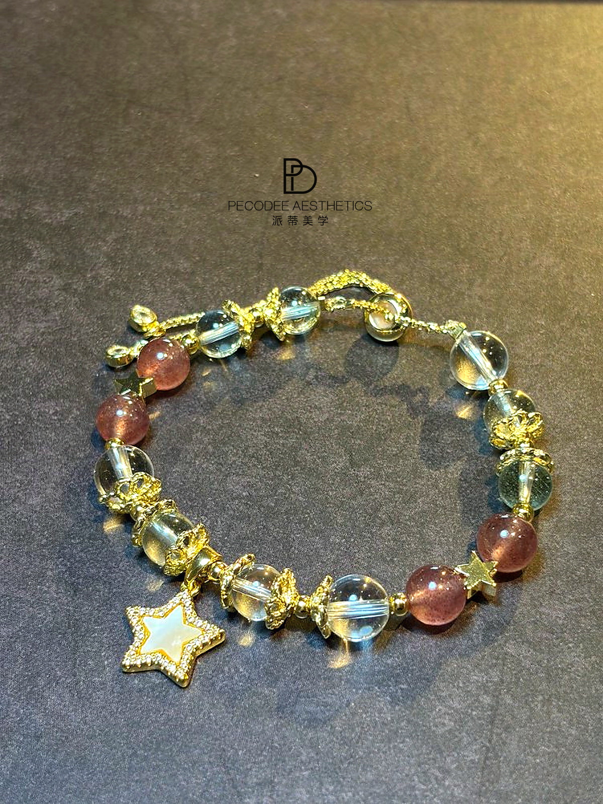 Gold-tone charm bracelet with blue and red-brown beads and star pendant