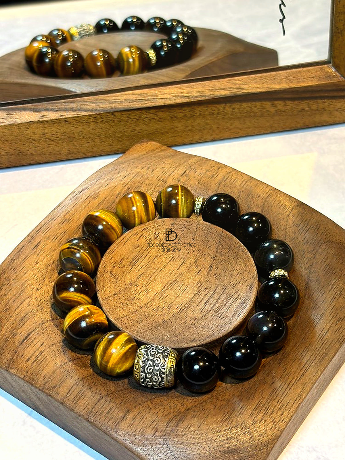 Tiger Cloud Guard beaded bracelet with black glass beads and gold striped stones, ornate divider