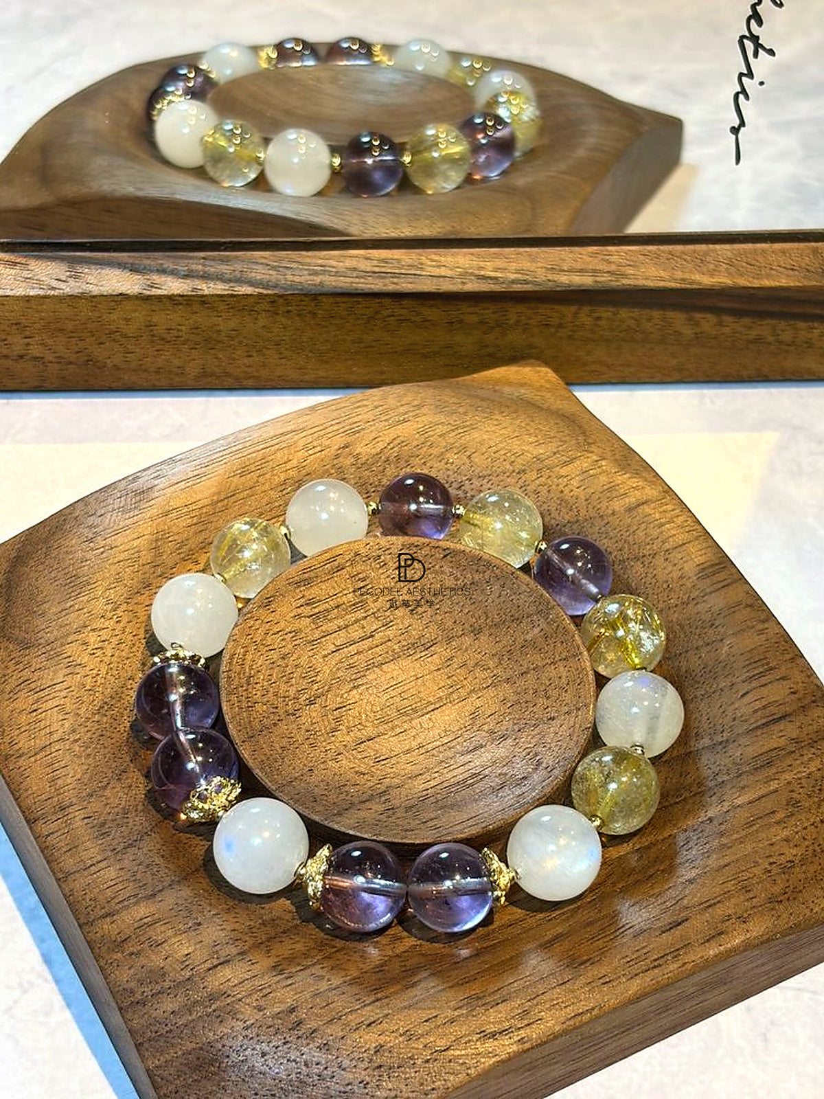 Beaded bracelet featuring white, blue-purple, and yellow/gold round beads